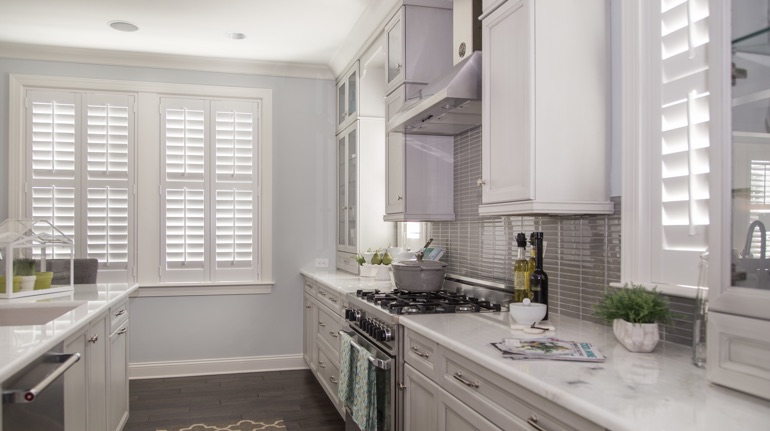 Plantation shutters in Fort Myers kitchen with white cabinets.
